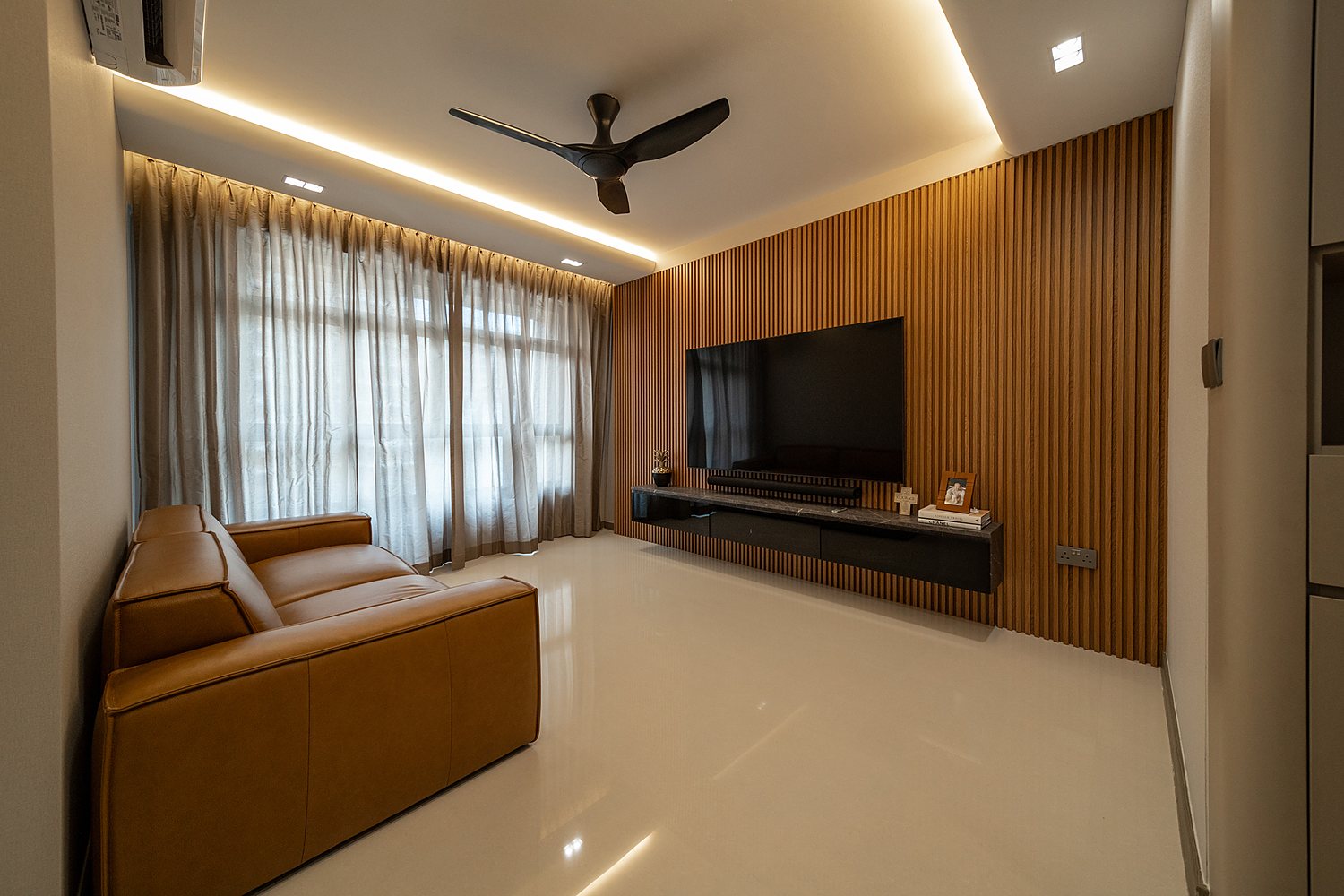 Warm contemporary living room with leather sofa and timber detailing