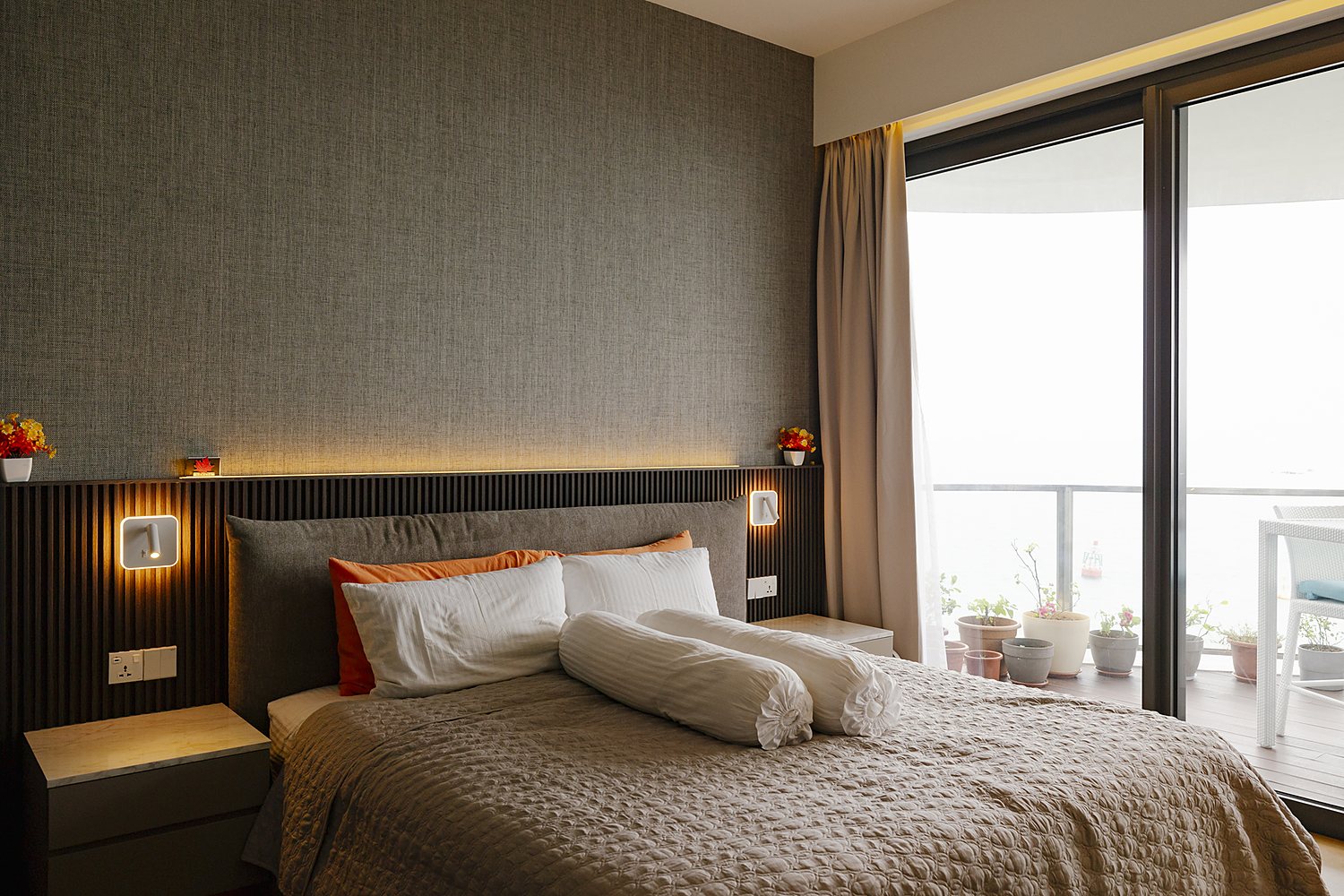 Warm bedroom interior with sea view by Creo Studio